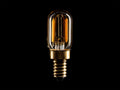Amber glass LED T22 Filament bulb with E12 base, vertically oriented. Bulb glows with warm light, gold screw base.