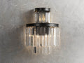 Leyland Sconce with multifaceted K9 glass crystals on an iron frame with oil-rubbed finish, mounted on a textured wall.
