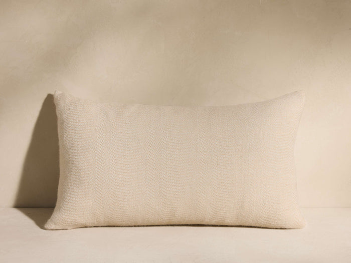 Horizontal Madera Alpaca Stripe Pillow, light beige, with a subtle woven chevron pattern, on a light surface.