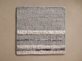 Maeve Rug Swatch: Square, textured light gray swatch with horizontal cream boucle and brown thread stripes.