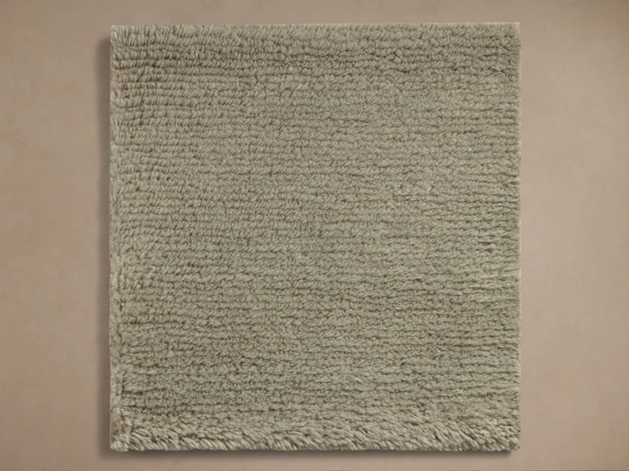 Square Maise Wool and Cashmere Hand-Knotted Rug Swatch in light sage green, showing dense, looped texture.
