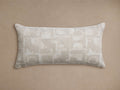 Marli Outdoor Lumbar Pillow. Rectangular, beige & off-white monochromatic woven pillow with abstract geometric pattern, on tan background.