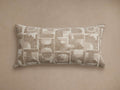 Marli Outdoor Lumbar Pillow, horizontal, with an abstract geometric pattern in monochromatic beige & tan, woven texture, on a tan background.