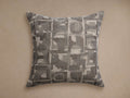 Marli Outdoor Pillow: Square, monochromatic gray/silver abstract pattern with woven texture, laid flat against a neutral wall.