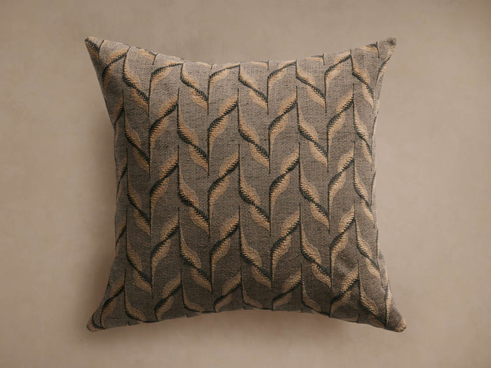 Square Matte Pillow featuring a textured abstract pattern of tan and dark grey feather-like shapes on a muted gray fabric.