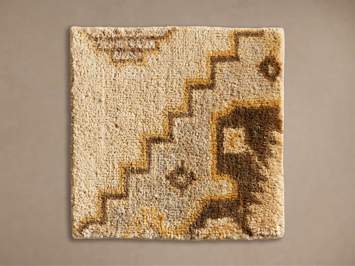 Maverick Hand-Knotted Rug Swatch, square, textured cream base with abstract brown and gold geometric patterns, laid flat.
