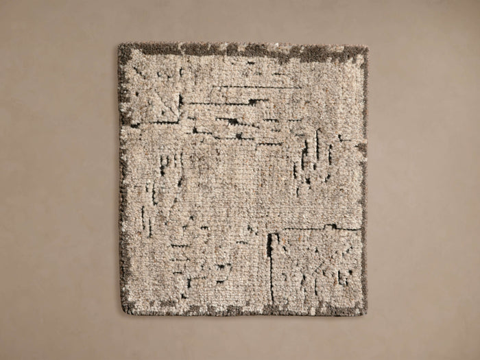 Mckenna Hand-Knotted Rug Swatch featuring a textured, mottled pattern in various shades of beige and gray, displayed on a neutral background.