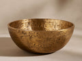 Harper Bowl, round, golden brass-finished bowl with heavily textured, distressed surface, shown from front.
