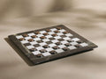 Metal Checkers Game Pieces: Antiqued brass and brushed nickel pieces arranged on a dark green marble and white checkerboard.