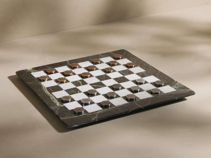 Metal Checkers Game Pieces: Antiqued brass and brushed nickel pieces arranged on a dark green marble and white checkerboard.