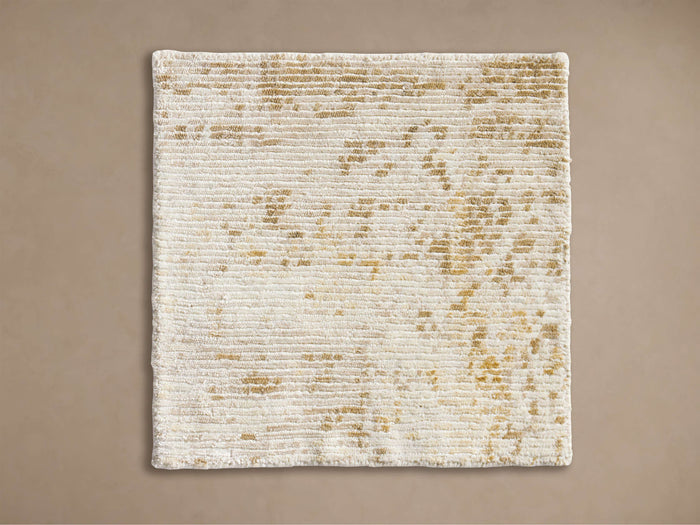 Miah Rug Swatch, cream with horizontal ribbed texture and irregular golden speckles, presented flat.