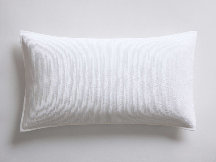 White Mira Voile Sham, rectangular, lying flat, showcasing its subtle, tight, horizontally stitched texture and neat hemmed edges.