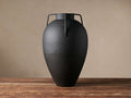 Matte black Modern Metal Vase with generous silhouette, tapered neck, and angular handles, on a wooden table.