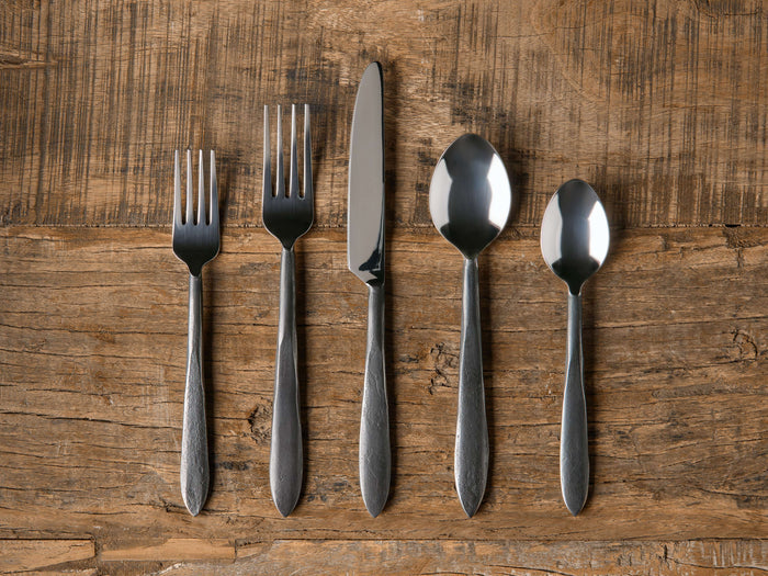 Murray Five Piece Place Setting on wood surface, displaying two forks, a knife, a spoon, and a teaspoon with tapered handles.
