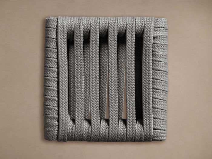 Naxos Outdoor Finish Board, a square board made of thick grey braided ropes forming vertical slats, on a beige background.