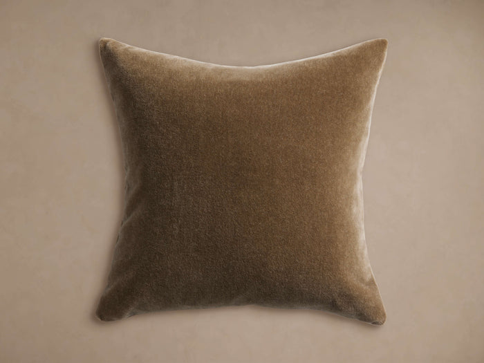 Square, soft brown mohair pillow with a subtle velvet-like sheen, centered on a light, warm neutral background.