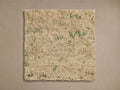 Nila Hand-Knotted Rug Swatch, beige surface with subtle green speckles, square-shaped, laid flat on a neutral background.