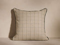 Northgate Piped Pillow with mocha-toned geometric pattern, black piping edges, and light beige grid design, against a neutral background.