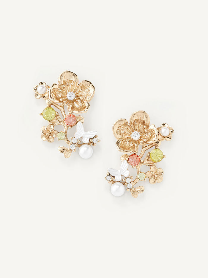 Pair of floral earrings with gold, green, and pearl accents on a white background