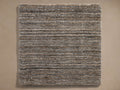 Top-down view of a rectangular rug with multi-toned, textured horizontal stripes in brown, gray, and off-white.