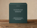 Outdoor Weathered Fawn Care Kit in a dark teal box with white text, on a light background and wooden surface.