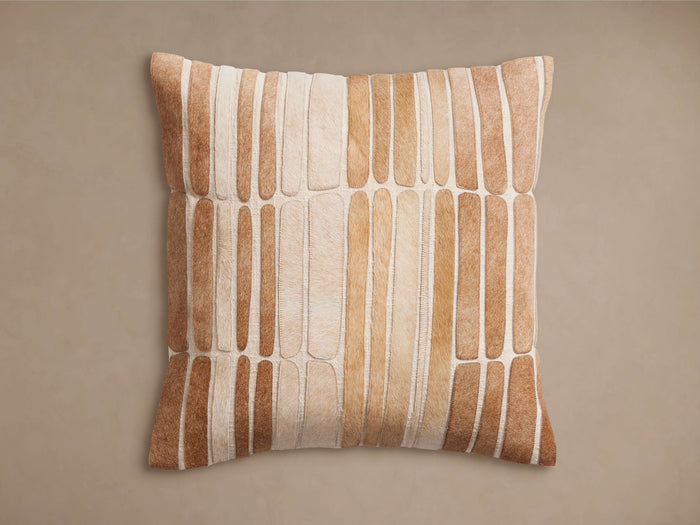 Pieced Hair on Hide Pillow with a mosaic of varying tan and brown oblong hair-on-hide patches, primarily arranged vertically.