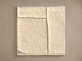 Porter Hand-Knotted Rug Swatch: Creamy white, plush textured sample with raised, defined lines, shown flat on a neutral background.