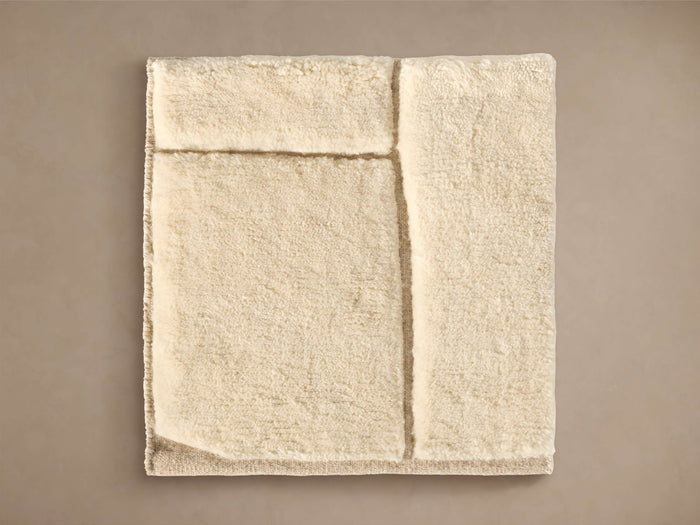 Porter Hand-Knotted Rug Swatch: Creamy white, plush textured sample with raised, defined lines, shown flat on a neutral background.