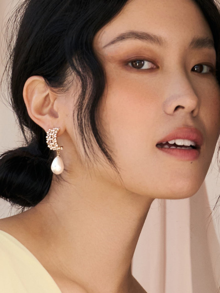 Close-up of a woman wearing an earring with a soft background