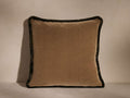 Quincy Fringe Pillow is beige with a plush velvet-like texture, featuring dark brush fringe along the edges, set against a neutral background.