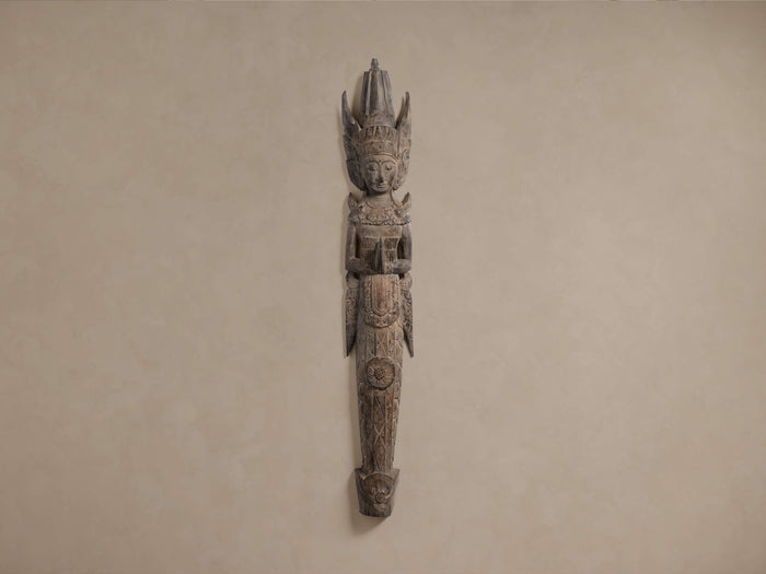 Rama Wall Sculpture, handcrafted dark wooden figure of a deity with headdress and clasped hands, mounted on a light wall.