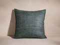 Front view of a dark teal Raw Silk Pillow, featuring hand-spun texture and merrow stitch edge detailing.
