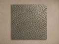 A square, dark grey Recycled Metal Finish Board with a textured hammered surface and an embossed butterfly design in the lower right.