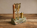 Rhodes Bar Tool Set: acacia wood muddler, gold bottle opener, strainer, knife, peg measure in green marble stand.