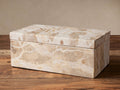 Rectangular Rhodes Box of natural beige marble with tan veining and a lid, placed on a dark wooden surface.