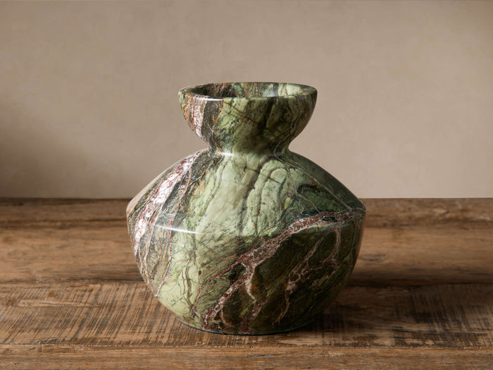 Rhodes Marble Vase in Green Forest. Sculptural, faceted green marble with distinct white and reddish-brown veining, standing on wood.