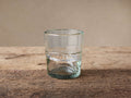 Ribbon Clear Double Old-Fashioned Glass on rustic wood. Recycled clear glass has a textured ribbon band, partially filled.