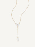 Gold necklace with a teardrop-shaped pendant on a white background