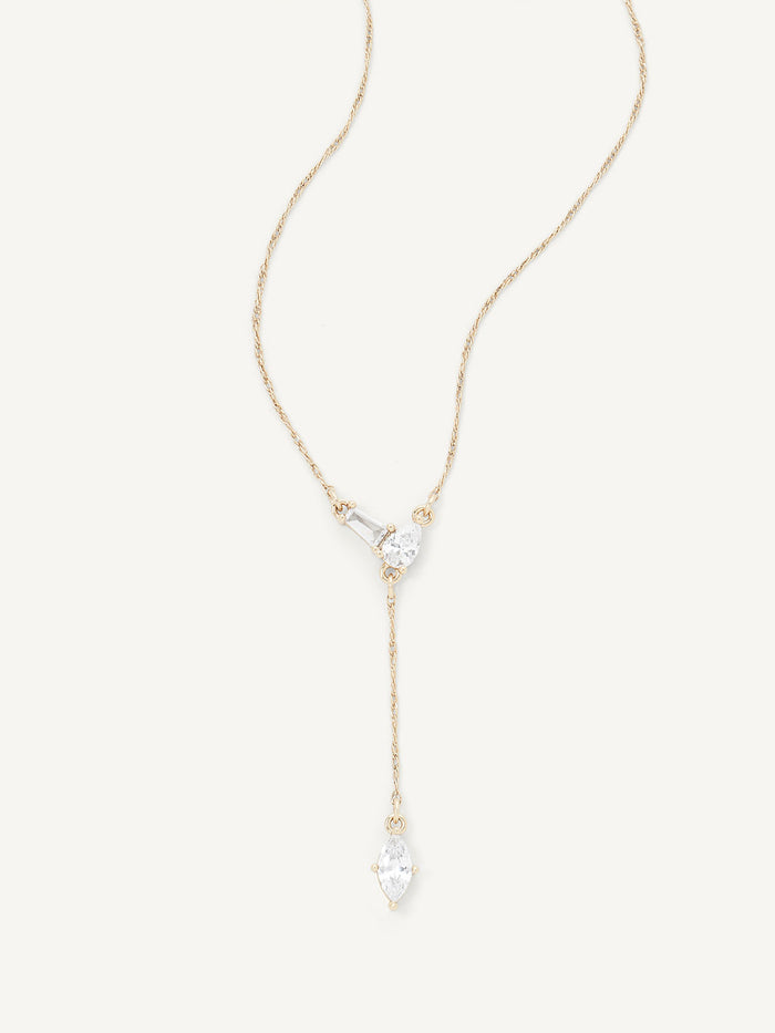 Gold necklace with a teardrop-shaped pendant on a white background