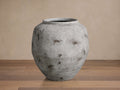 Large, rounded Rustic Grey Vessel, a distressed light grey terracotta vase with dark brown accents, standing on a wooden floor.