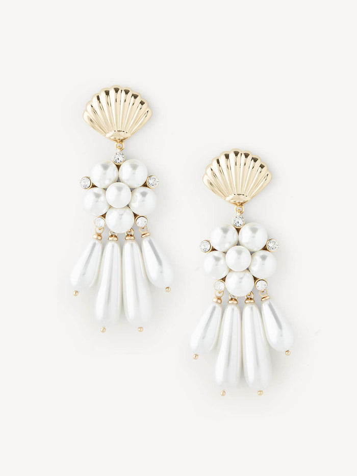 A pair of gold and white shell-shaped dangle earrings with pearl-like beads and small clear rhinestone accents, displayed on a clean off-white background.