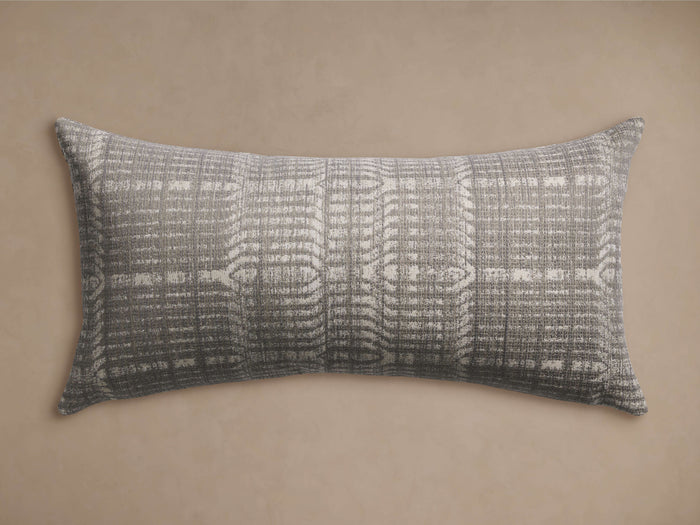 Horizontal Siene Outdoor Lumbar Pillow with a textured grey and off-white abstract woven pattern, displayed on a plain beige background.