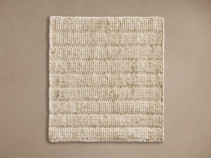 Rectangular Silo Rug Swatch with light beige natural woven texture and horizontal lines, laid flat on a muted brown background.