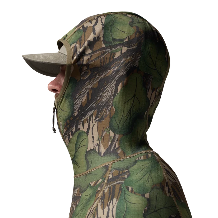 Sixty Series Technical Fleece Half Zip with Hood in Mossy Oak Full Foliage, on model #mossy_oak_full_foliage