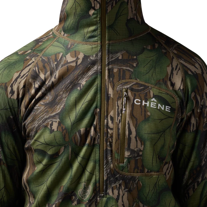 Sixty Series Technical Fleece Half Zip with Hood in Mossy Oak Full Foliage, on model #mossy_oak_full_foliage