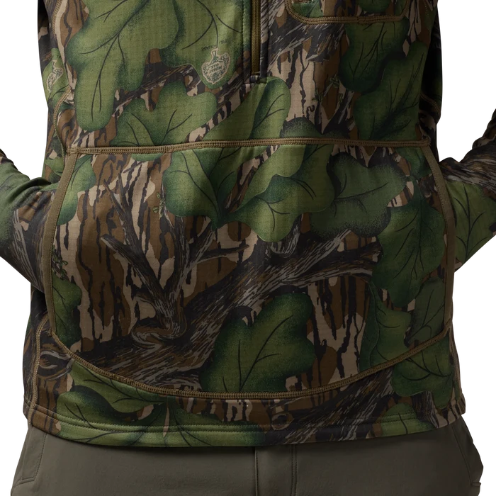 Sixty Series Technical Fleece Half Zip with Hood in Mossy Oak Full Foliage, on model #mossy_oak_full_foliage