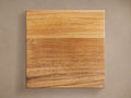 Montego Outdoor Teak Finish Board, square and flat, displaying rich warm brown natural wood grain against a neutral background.