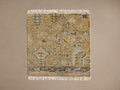 Stein Hand-Knotted Rug Swatch: Beige hand-knotted swatch with abstract blue, grey, gold pattern, dark border, white fringes.
