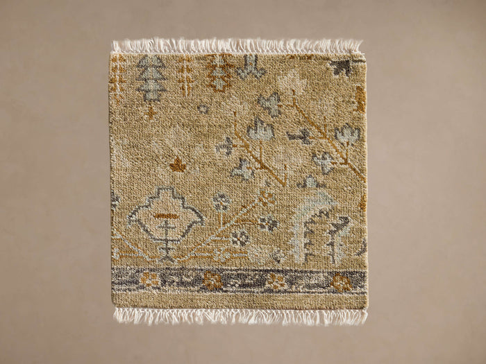 Stein Hand-Knotted Rug Swatch: Beige hand-knotted swatch with abstract blue, grey, gold pattern, dark border, white fringes.