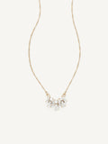 Gold necklace with small gems on a white background